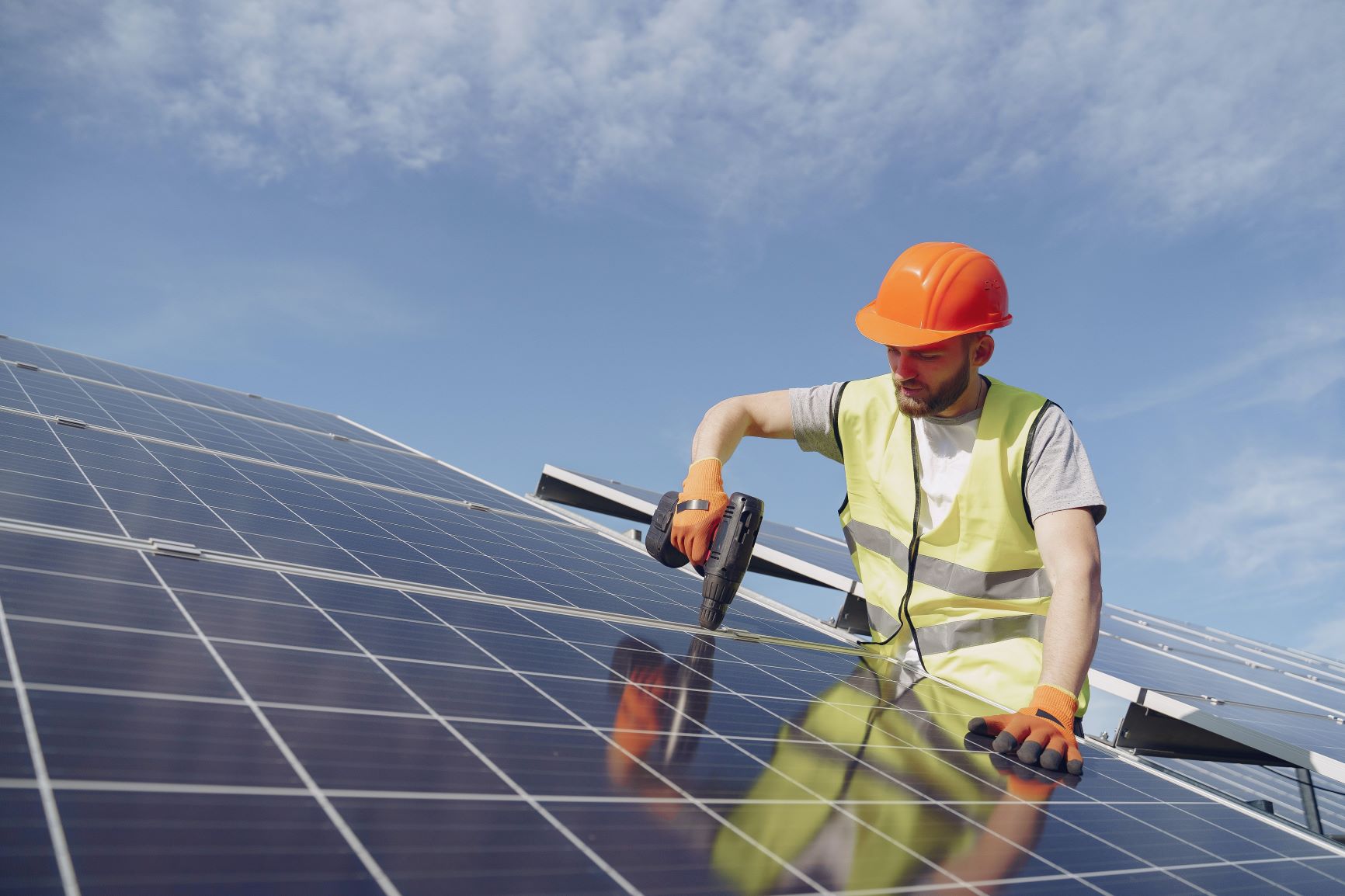 image of man working on a solar panel